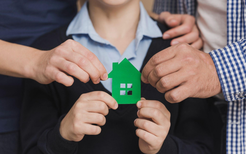 Housing Stability and Community Well-Being represented by a family supporting secure housing
