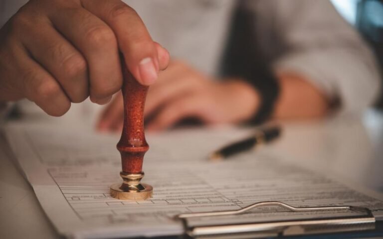 Person stamping an official document for FBI background check apostille and international document authentication.